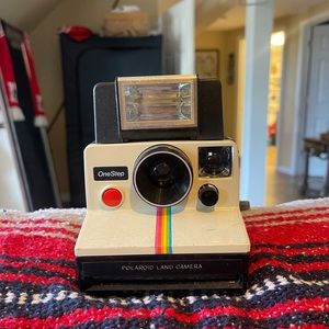 1979 Polaroid camera with flash and carrying bag.